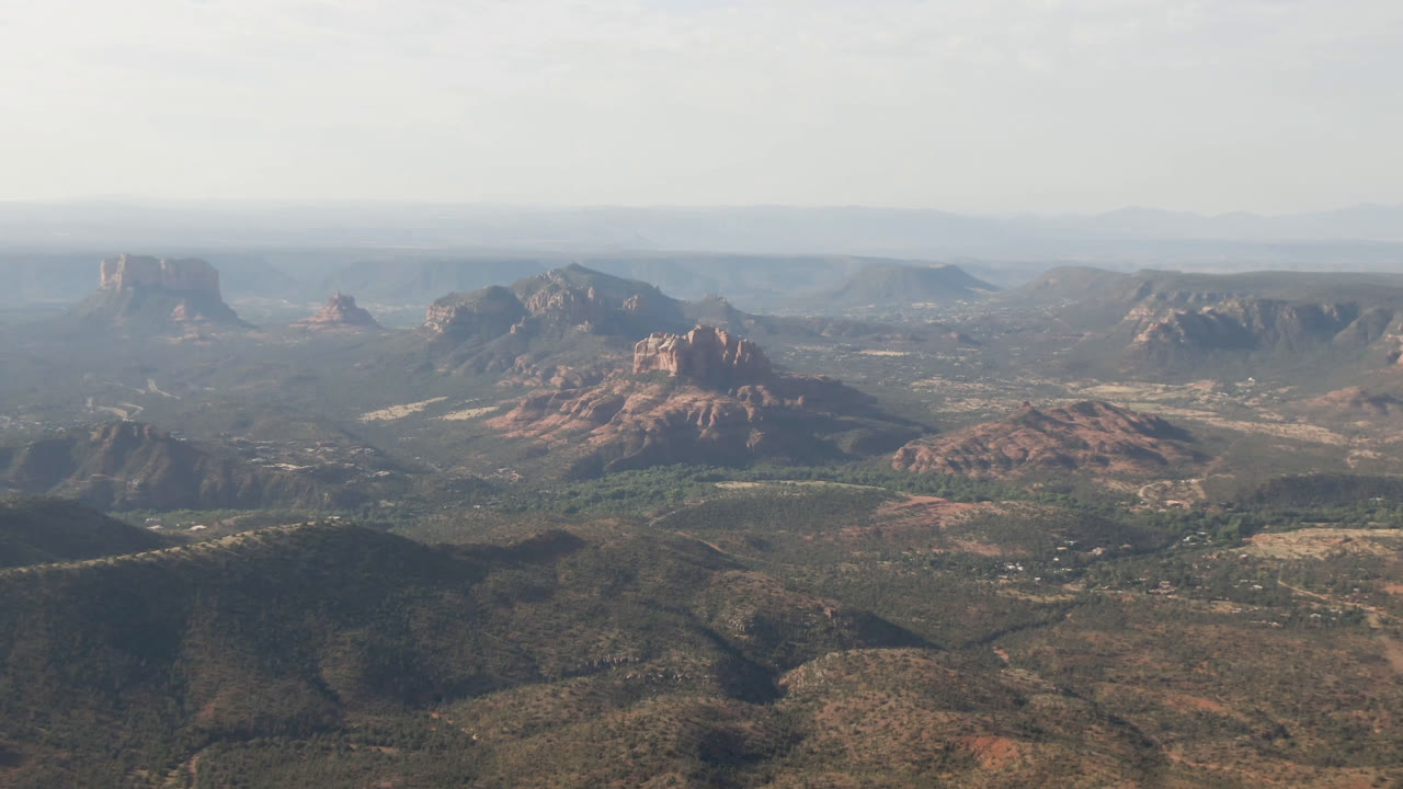Red rock ridges and mesa shapes spread across a broad high desert valley.