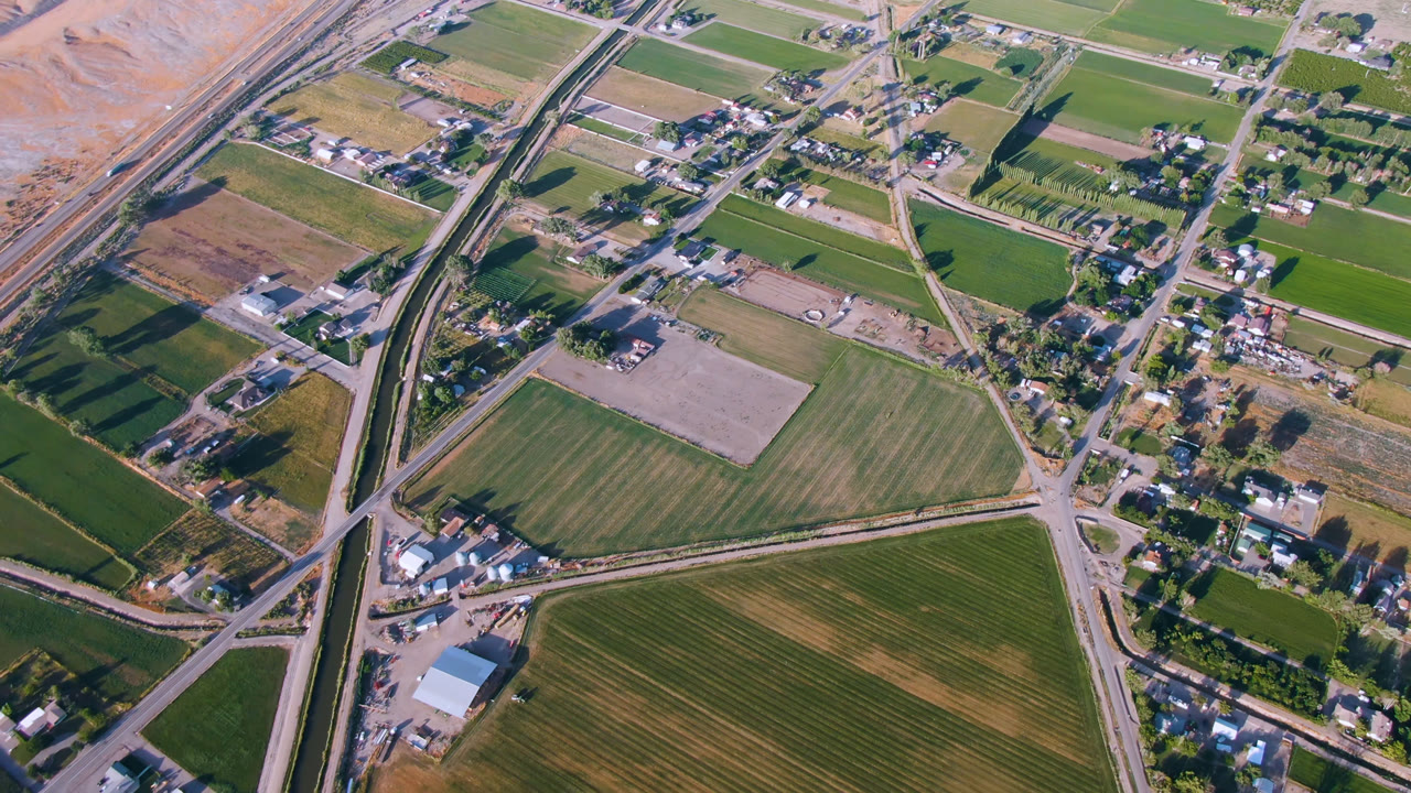 Aerial view of fields, roads, homes, and dry hillside