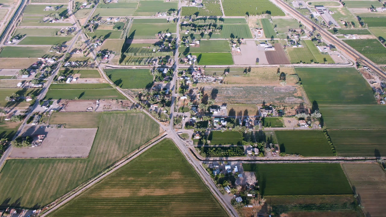 Aerial view of farm fields, roads, and small town buildings