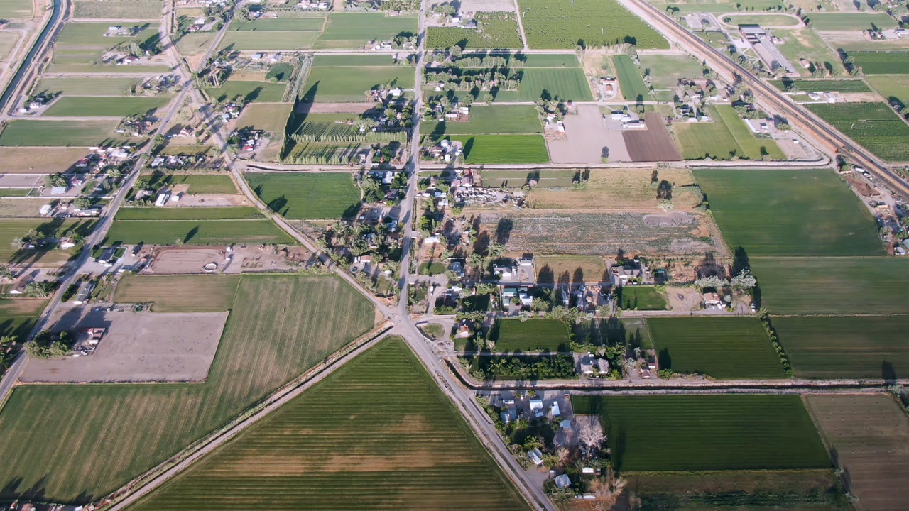 Second frame over Palisades, Colorado shows rectangular farm fields, clusters of homes, a straight horizontal corridor, diagonal roads, and no visible people.