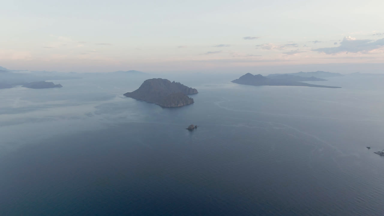 At three seconds, the Danzante Bay frame places the dark island on the left side of the composition, with a small boat below it, distant islands across the horizon, and no visible people.
