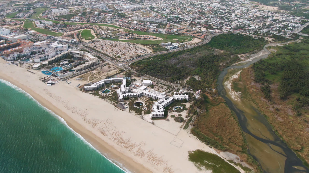 Aerial view of beach resort beside a river and ocean shoreline