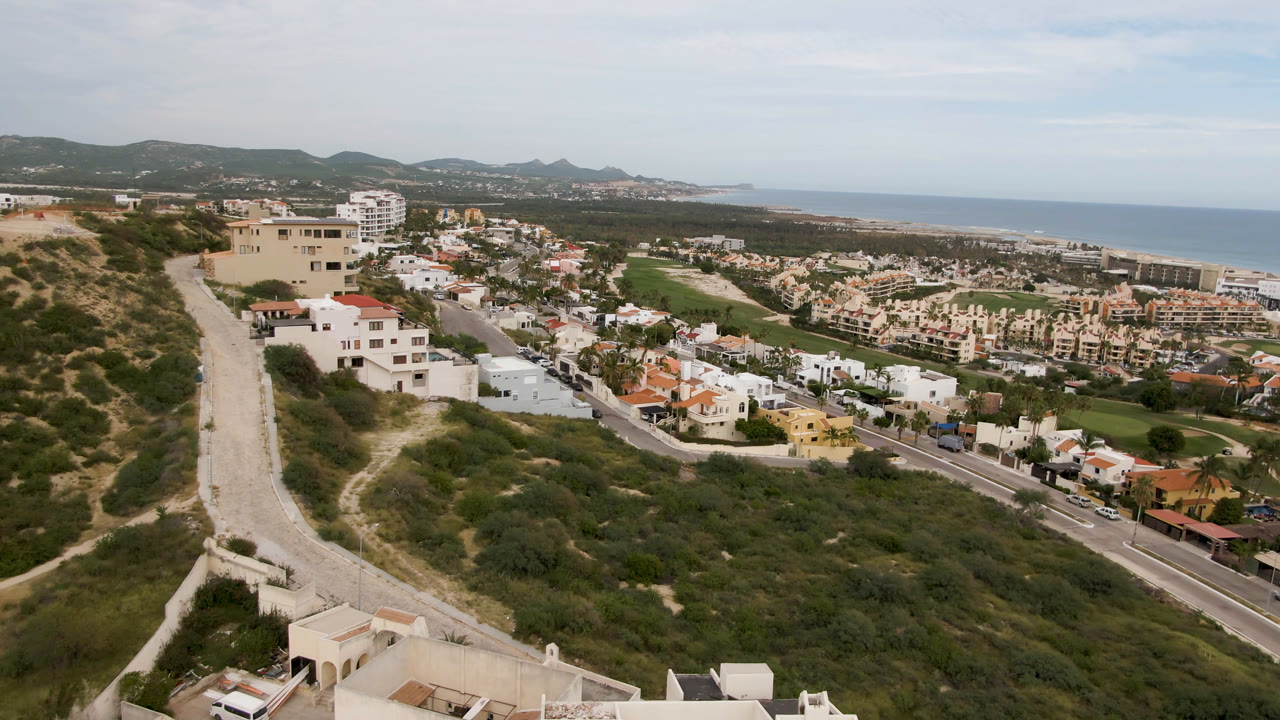 Aerial coastal neighborhood with beach and ocean in the distance
