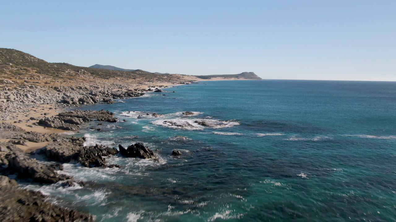 Blue ocean beside a rocky Baja California Sur shoreline.