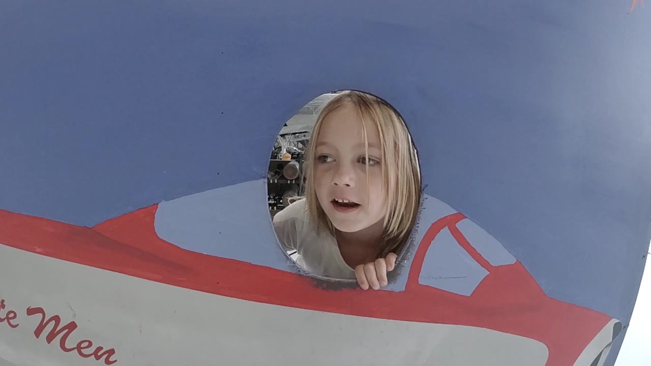 Child faces forward through the round cutout.