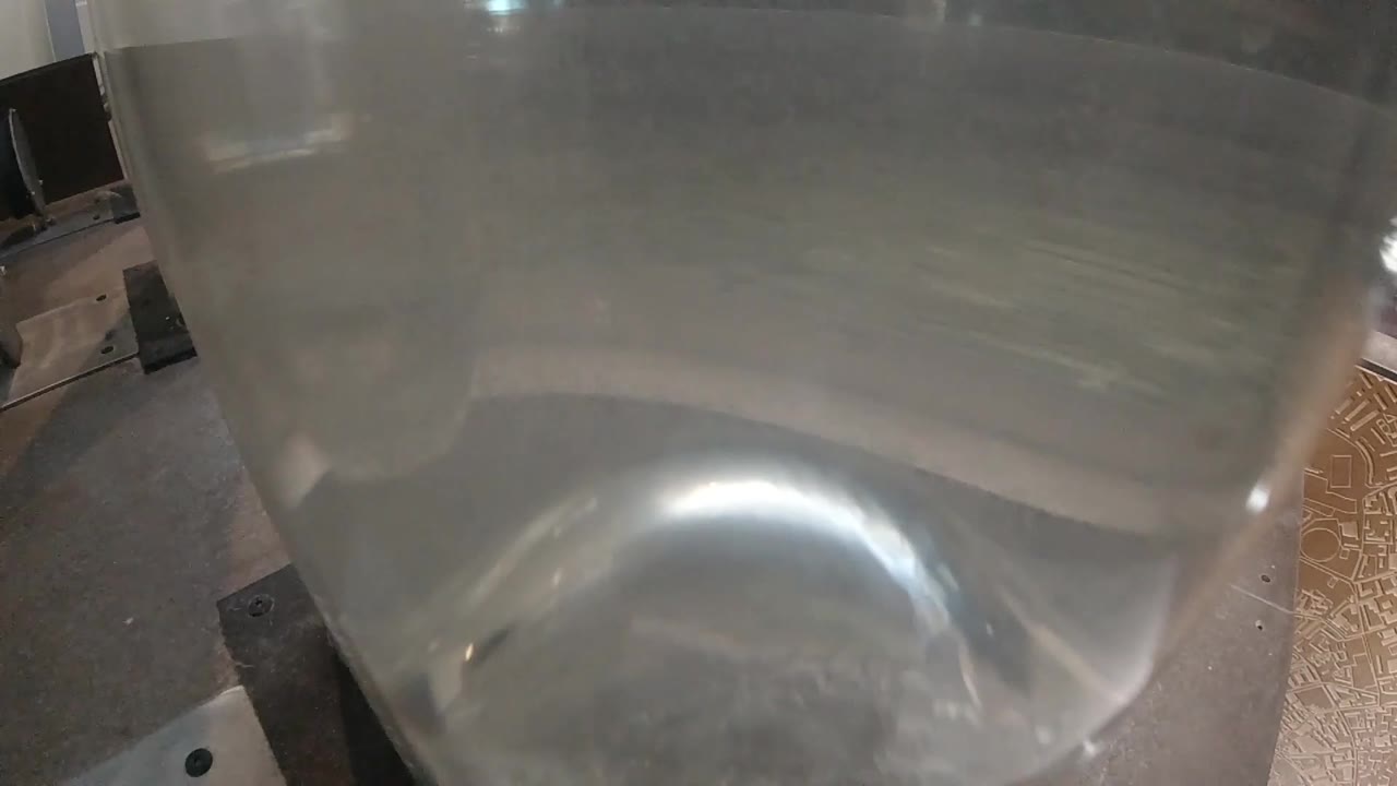 Clear container with water showing initial small bubbles beginning to form