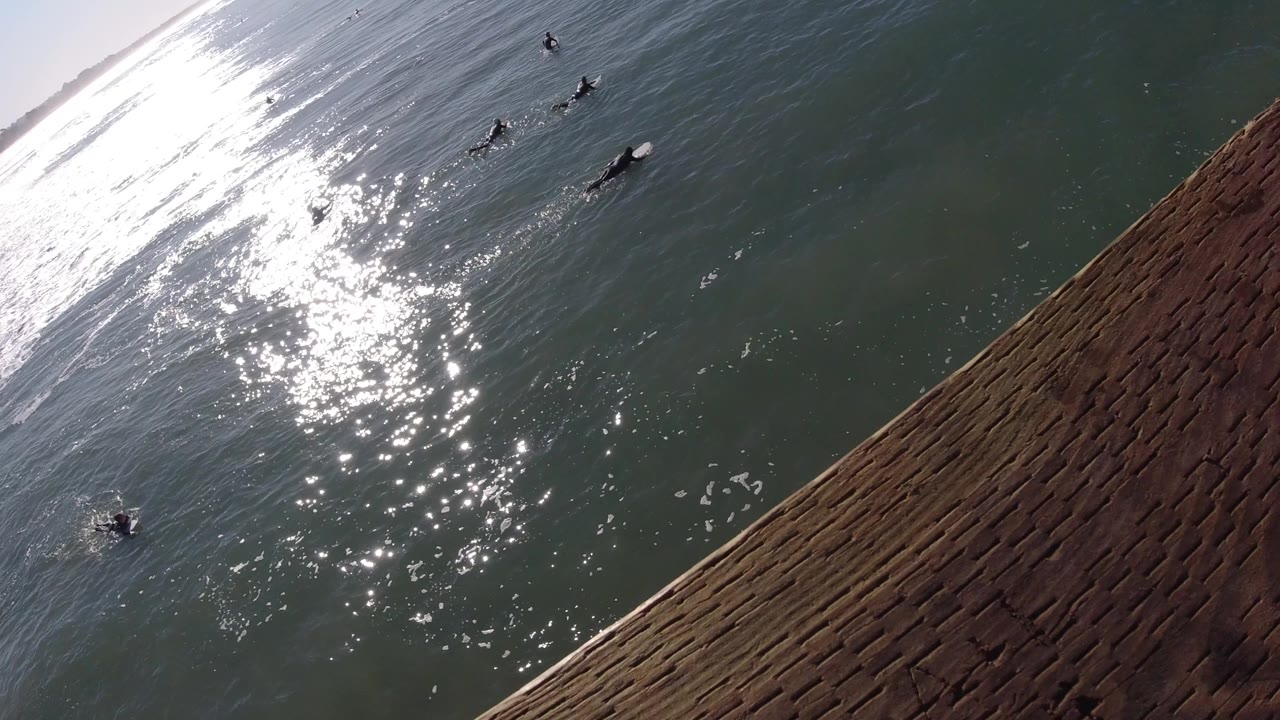 Ocean glare and wooden railing from a high angle.