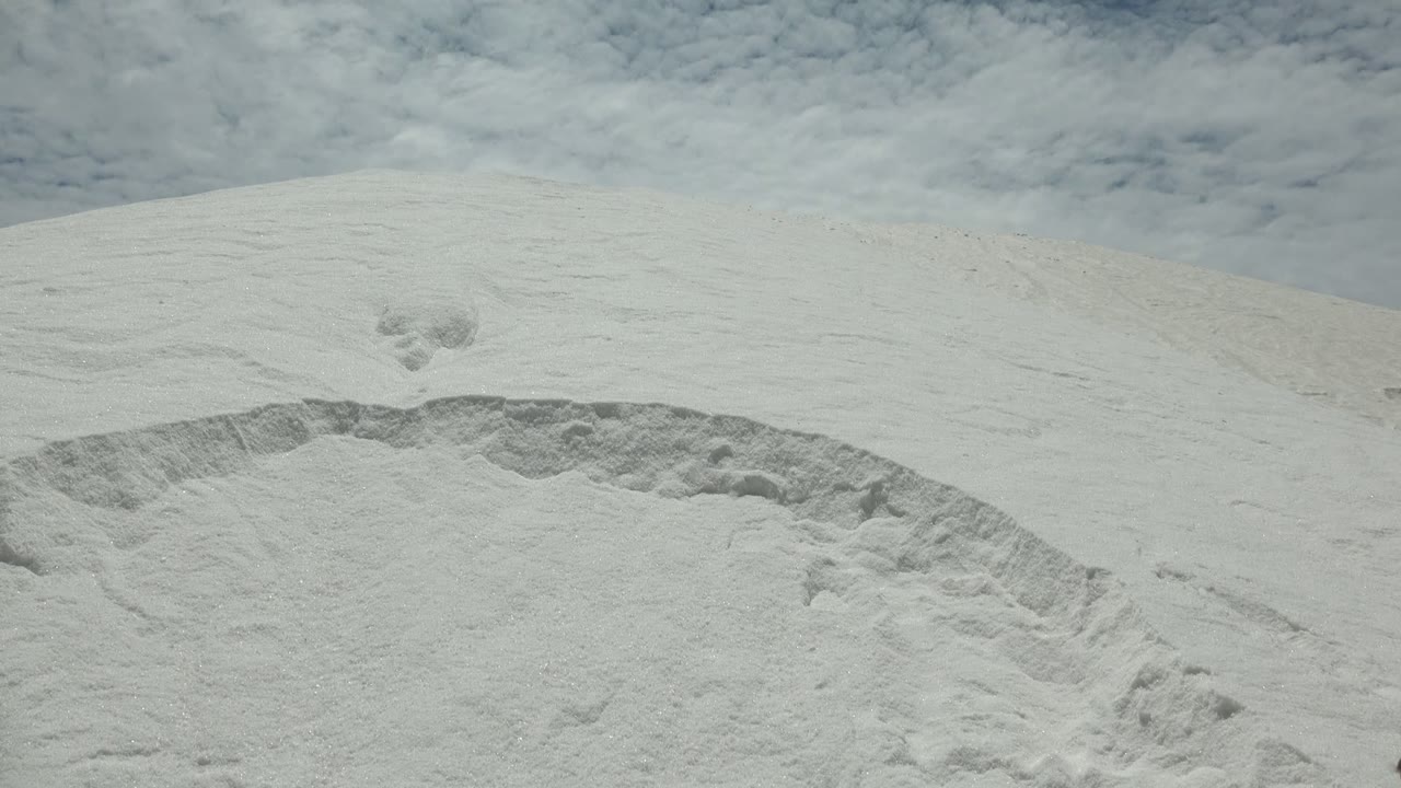 Pale dune slope with clouds above