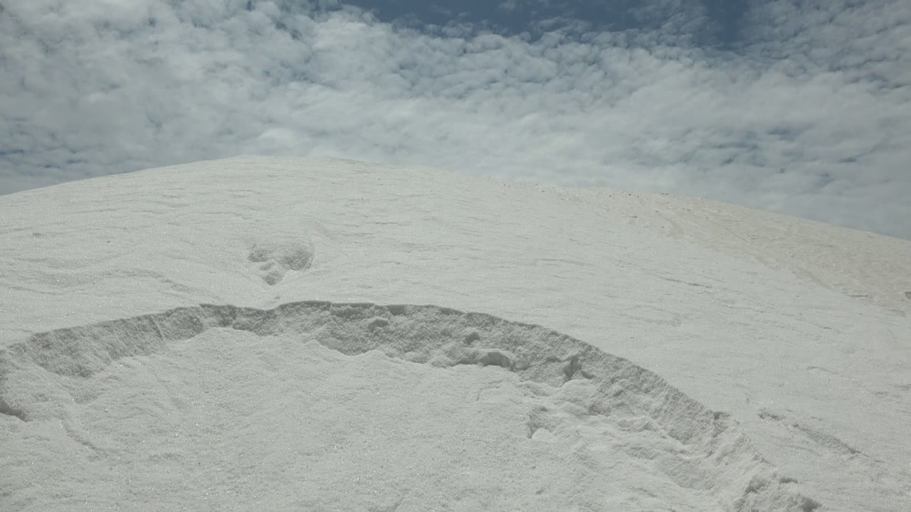 White dune ridge in Guerrero Negro BCS Mexico with a broad pale surface, darker cloud texture above, and no visible people.