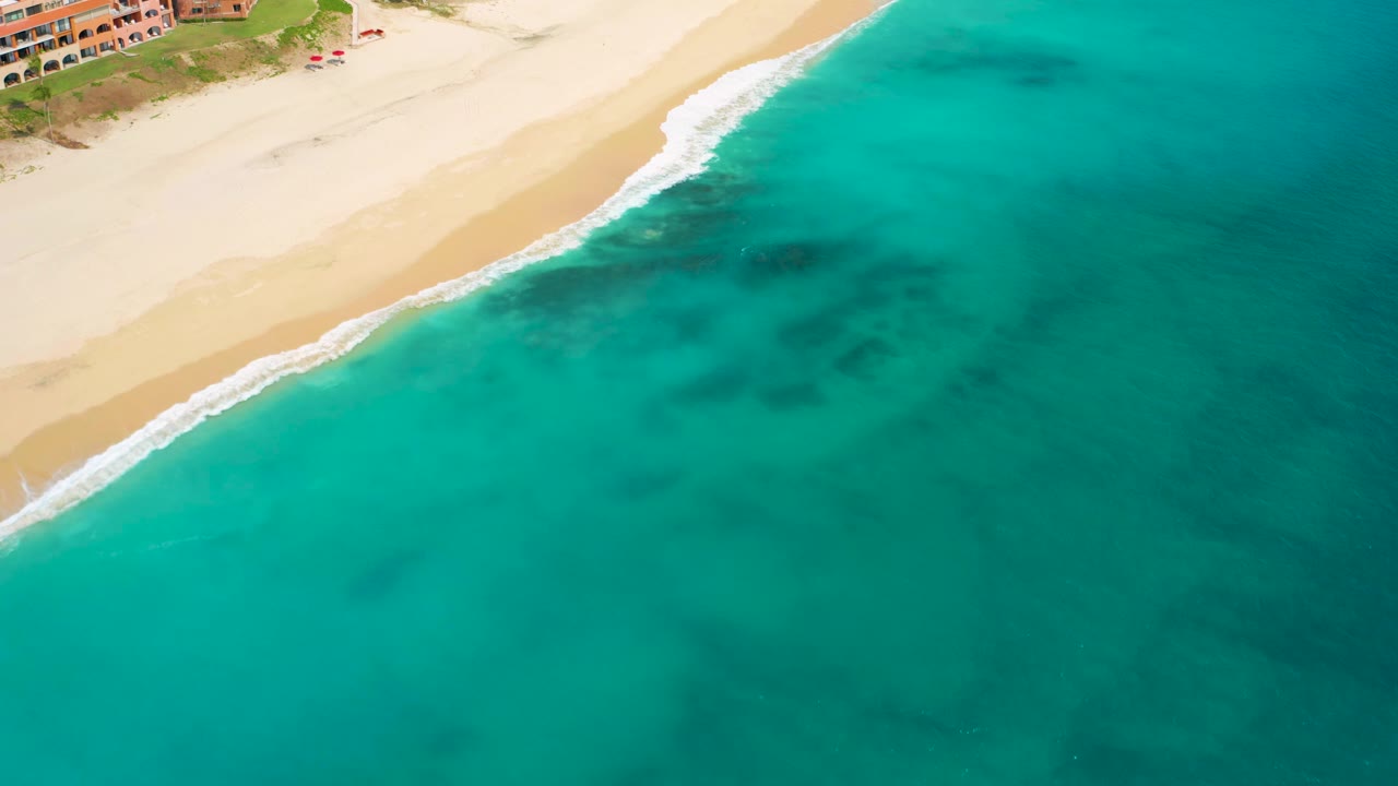 Aerial shoreline with white waves and turquoise water