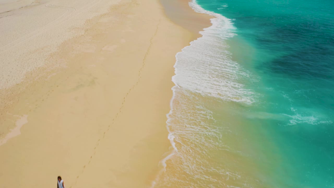 Drone view of surf line and open sandy beach