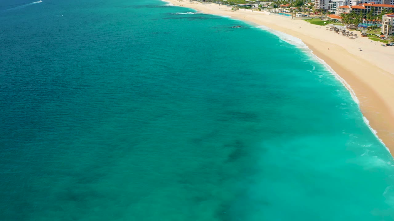 Aerial coastline with aquamarine water and pale beach
