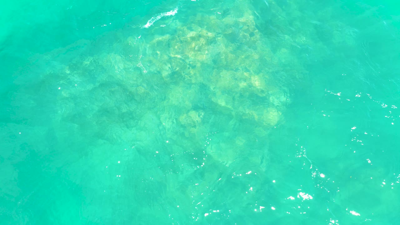 Clear turquoise water above a pale rocky seabed at Marquis Los Cabos BCS Mexico, with no visible people.