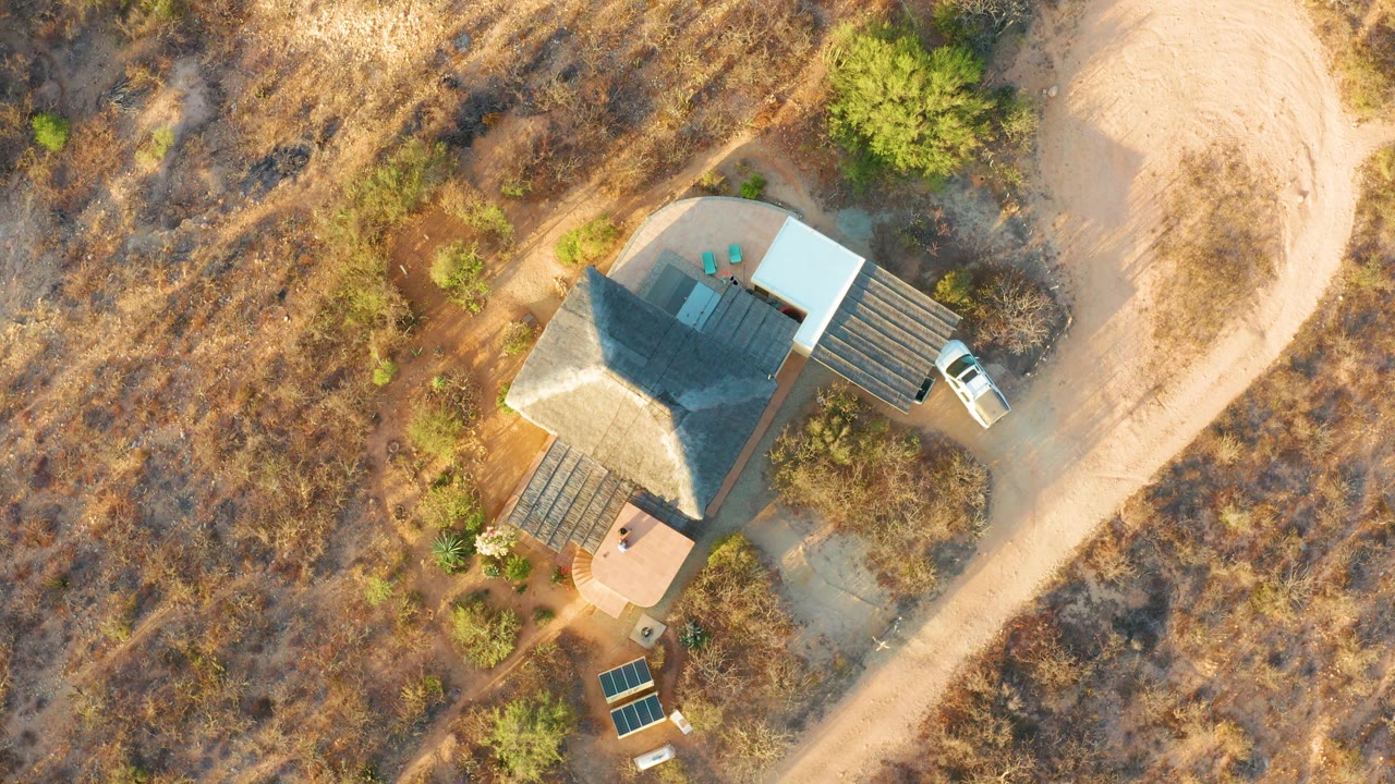 Overhead house view with deck areas and a truck at the driveway.