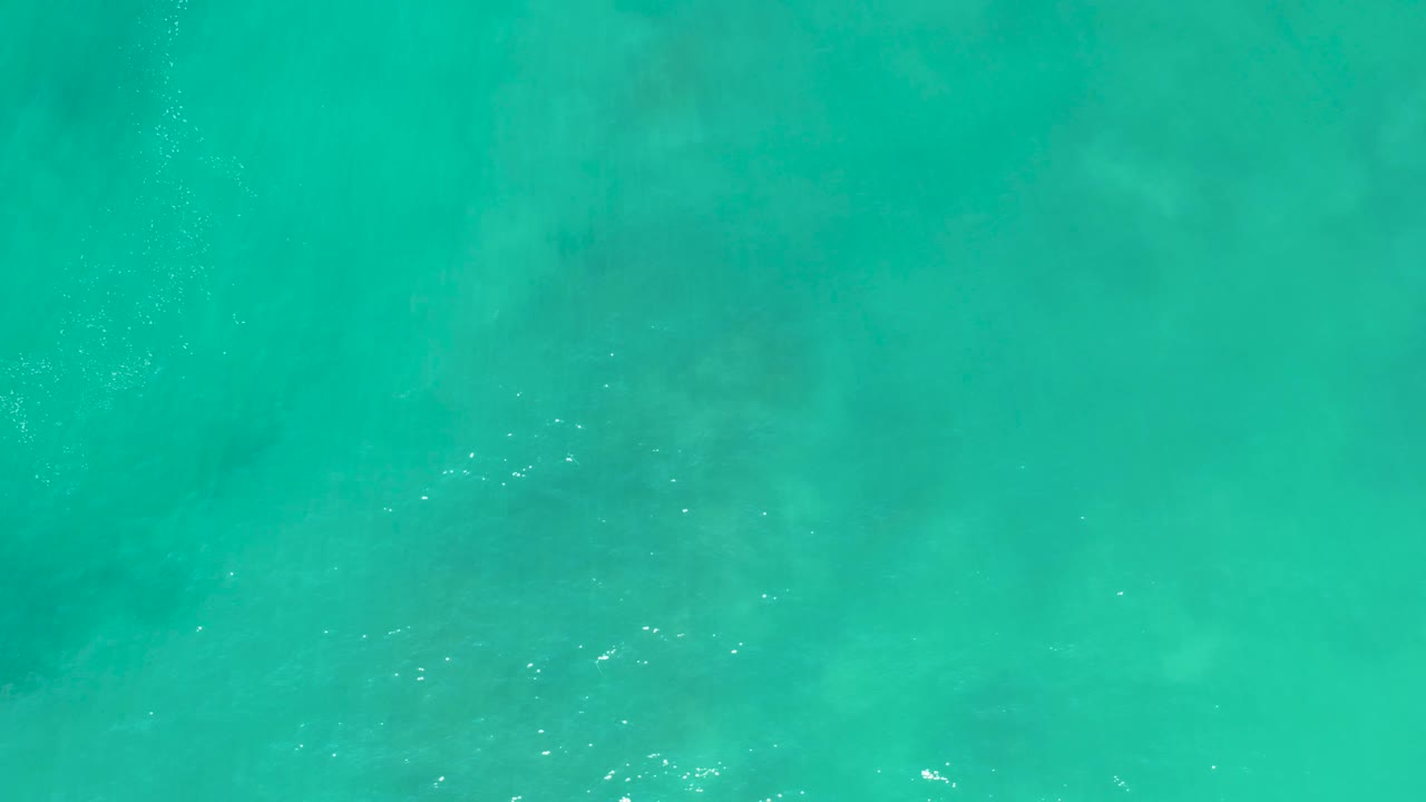Clear blue-green water fills the frame at San Luis Beach East Cape Los Cabos Mexico, with faint seabed variation and no visible people.