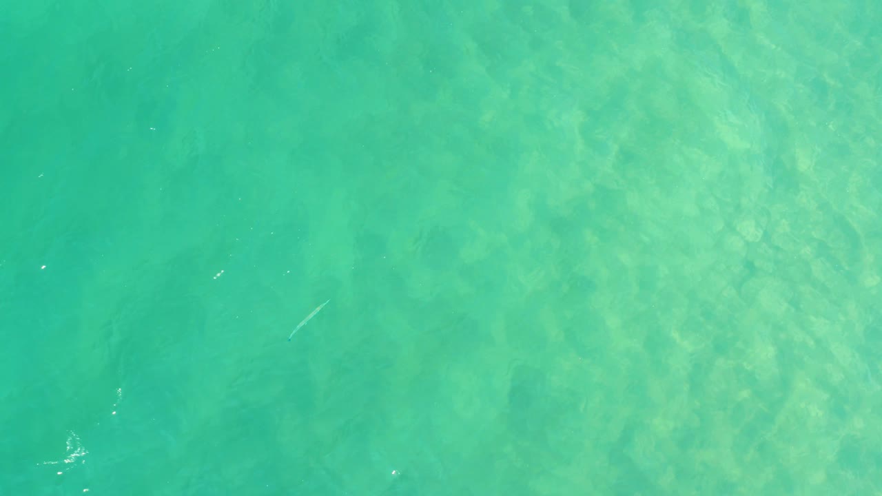 Overhead turquoise shallow water with faint underwater texture.