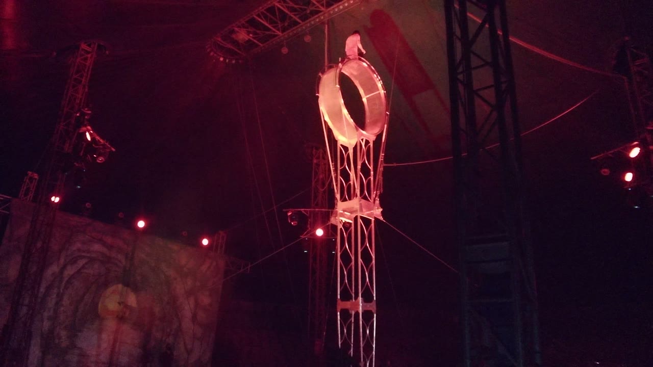 A red-lit hanging ring prop with a white ladder-like frame appears above a partially visible screen in San Jose del Cabo, Mexico, with no visible people.