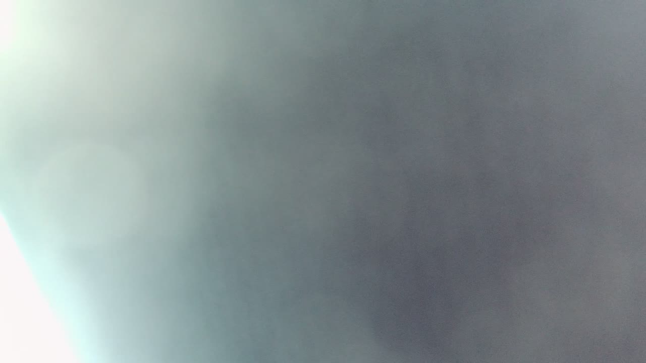 A Cabo Pulmo, Mexico frame seen through a foggy or dirty window, with a washed-out white flare on the left and no visible people.
