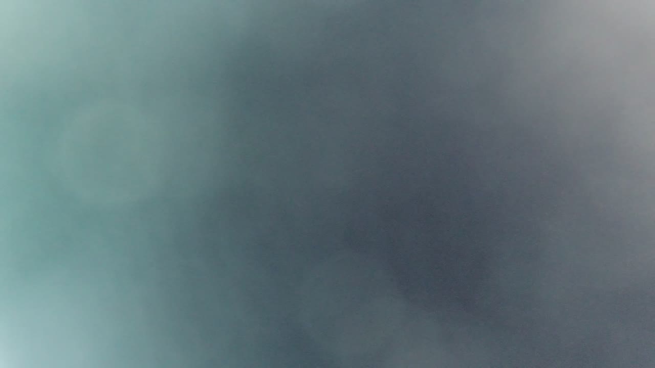 Defocused green-gray window view with a pale vertical light area