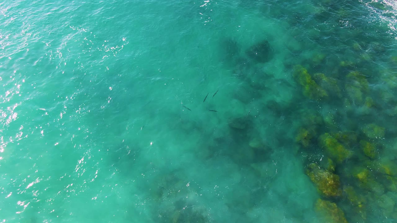 Clear sea surface with underwater rock patches