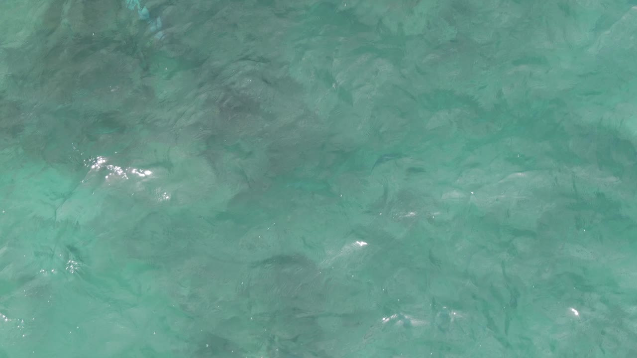 Transparent turquoise water with soft waves across the surface.