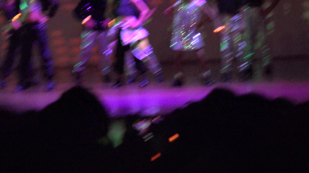 Children perform on a stage in San Jose Del Cabo BCS Mexico, with motion blur, purple lighting, and audience silhouettes along the lower foreground.
