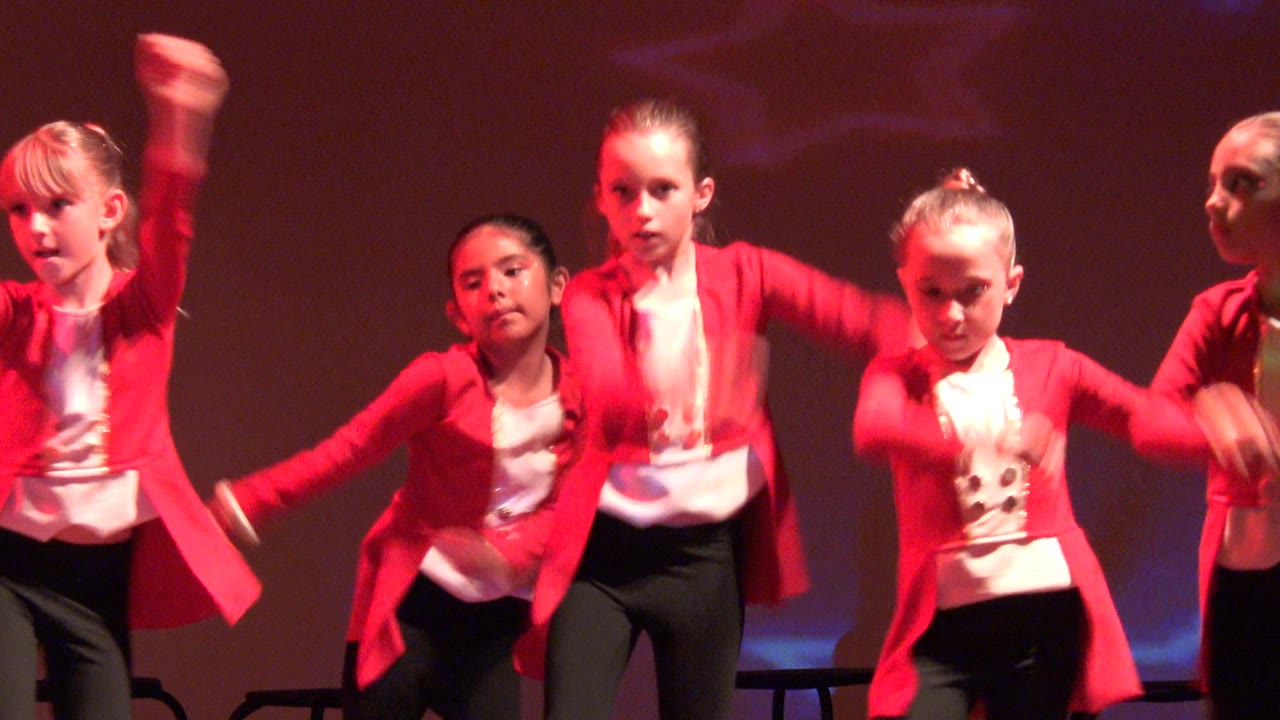 Two seconds into the San Jose del Cabo BCS Mexico clip, the children remain tightly grouped on stage, with one dancer centered and others raising arms beside her.
