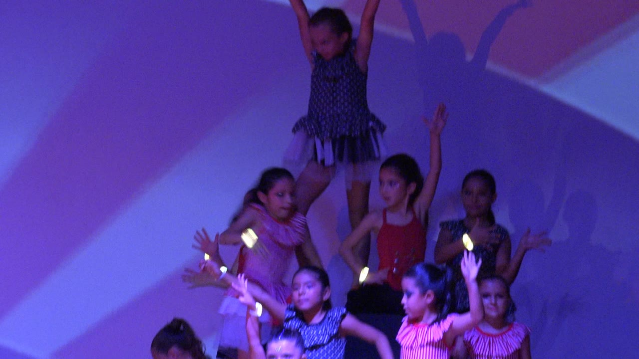 Children holding a stage dance pyramid formation