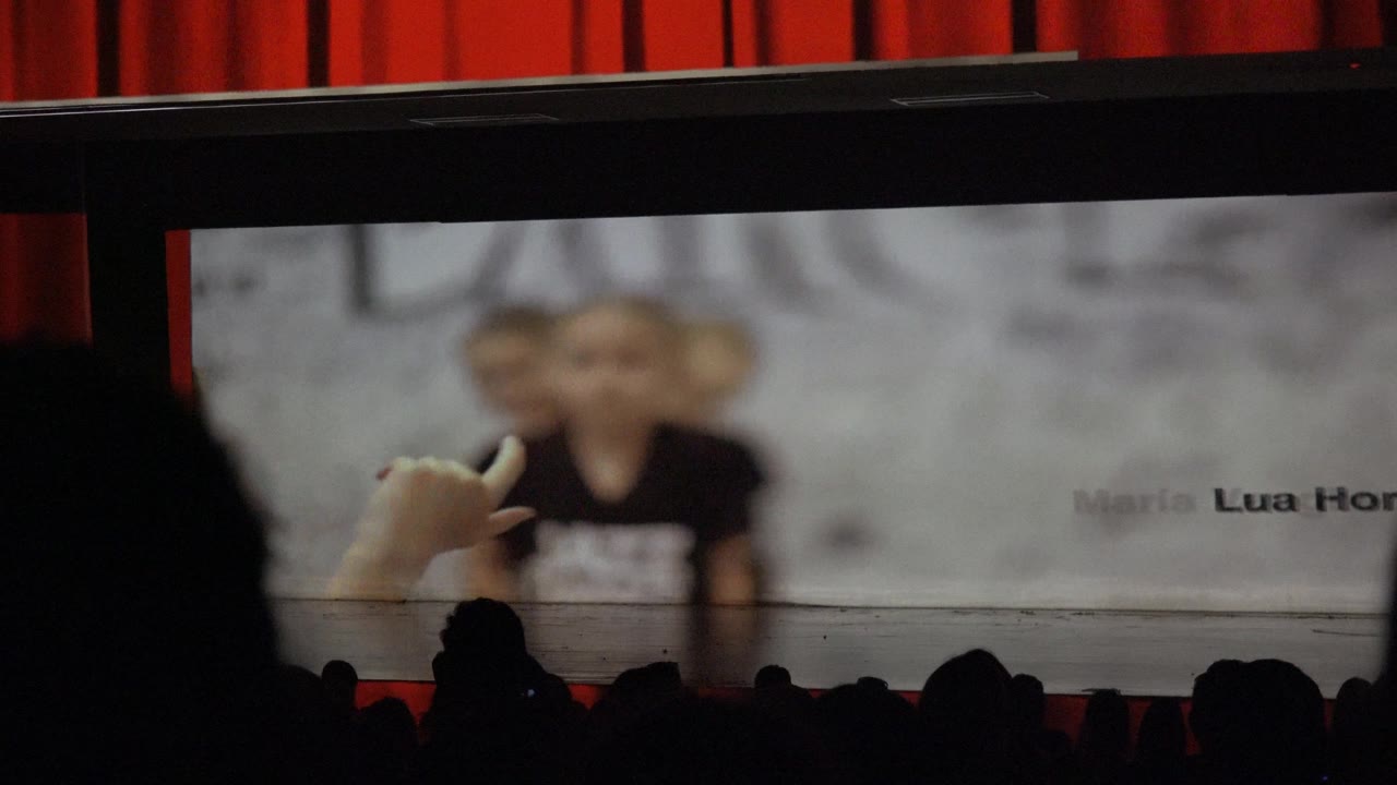 Blurred child dancer gesture on stage screen