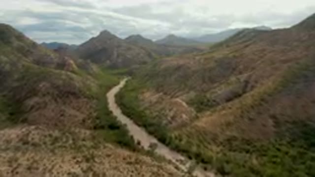 CABO PULMO BCS MEXICO-2024: Winding River in a Mountainous Valley