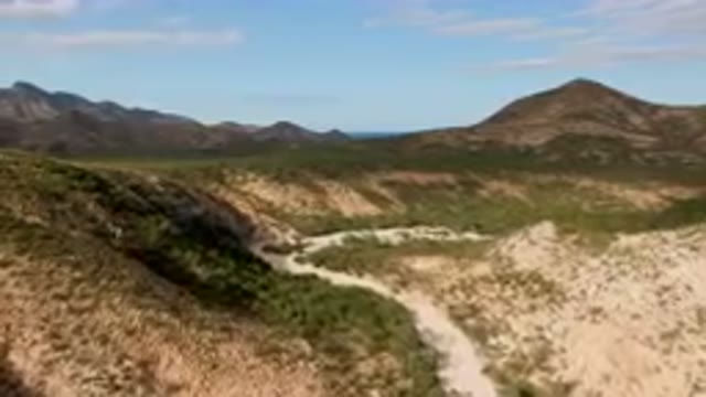 CABO PULMO BCS MEXICO-2024: Mountains And A Dirt Road In The Middle Of A Desert
