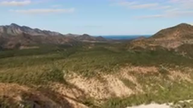 CABO PULMO BCS MEXICO-2024: Mountains With A Few Trees And A Body Of Water In