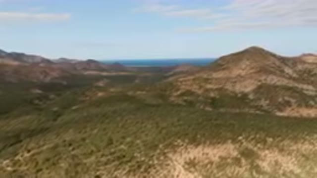 CABO PULMO BCS MEXICO-2024: Mountain Range With A Body Of Water In The Distance