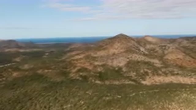 CABO PULMO BCS MEXICO-2024: Aerial View of Arid Mountains and Palm Forest with Ocean in Distance