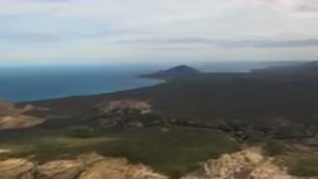 CABO PULMO BCS MEXICO-2024: Mountain Range With A Body Of Water In The Distance