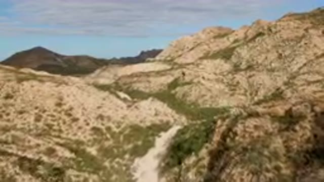CABO PULMO BCS MEXICO-2024: Man Riding A Horse On A Trail In The Mountains