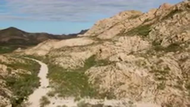 CABO PULMO BCS MEXICO-2024: Dirt Road Going Through A Rocky Mountain Valley