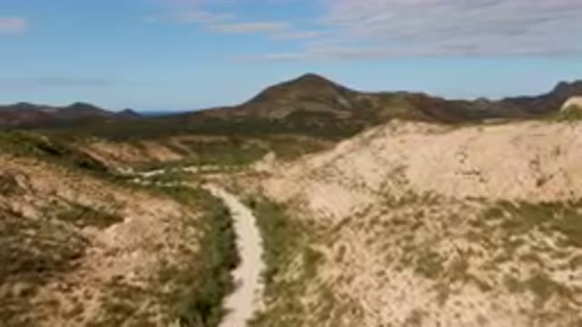 CABO PULMO BCS MEXICO-2024: Dirt Road Going Through A Valley In The Mountains