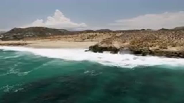 LAGUNA BEACH EAST CAPE BCS MEXICO-2023: Man Riding A Surfboard On The Ocean