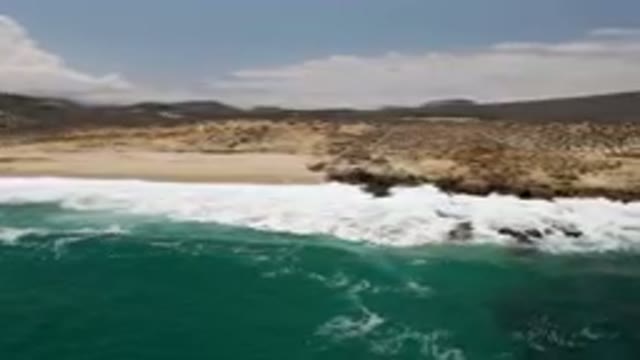 LAGUNA BEACH EAST CAPE BCS MEXICO-2023: Man Riding A Surfboard On The Beach