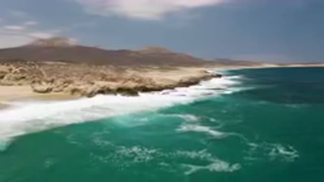LAGUNA BEACH EAST CAPE BCS MEXICO-2023: Beach With A Mountain In The Background