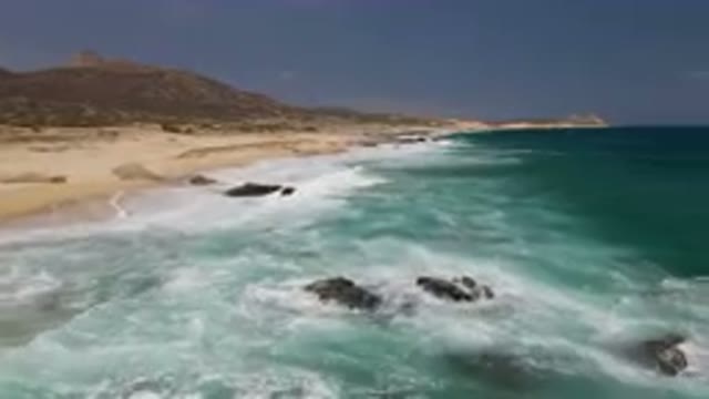 LAGUNA BEACH EAST CAPE BCS MEXICO-2023: Beach With A Mountain In The Background