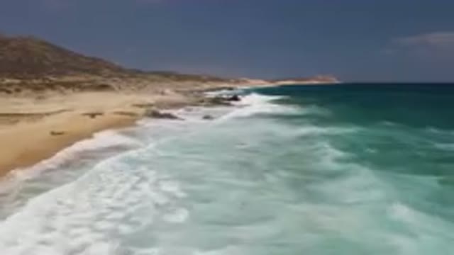LAGUNA BEACH EAST CAPE BCS MEXICO-2023: Arafly Rocky Beach With A Body Of Water