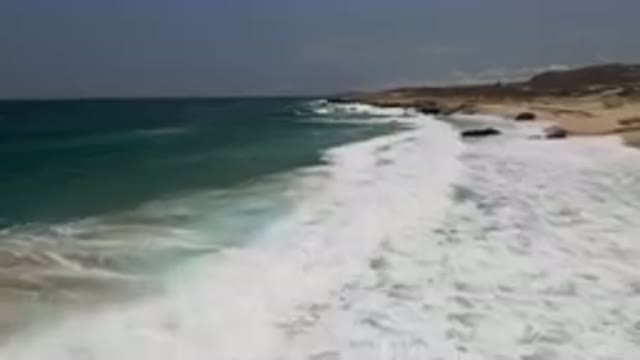 LAGUNA BEACH EAST CAPE BCS MEXICO-2023: Man Riding A Surfboard On The Beach