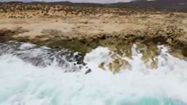 LAGUNA BEACH EAST CAPE BCS MEXICO-2023: Surfers Riding Waves On A Rocky Shore