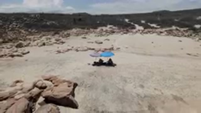 EAST CAPE, BCS MEXICO-2023: Two People Sitting On A Secluded Beach