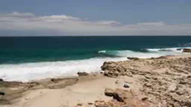 LAGUNA BEACH EAST CAPE BCS MEXICO-2023: Person On A Surfboard Riding On The Waves