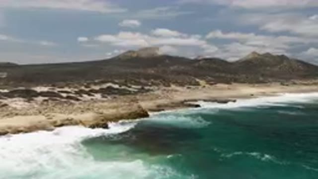 LAGUNA BEACH EAST CAPE BCS MEXICO-2023: Large Body Of Water With A Mountain In Background