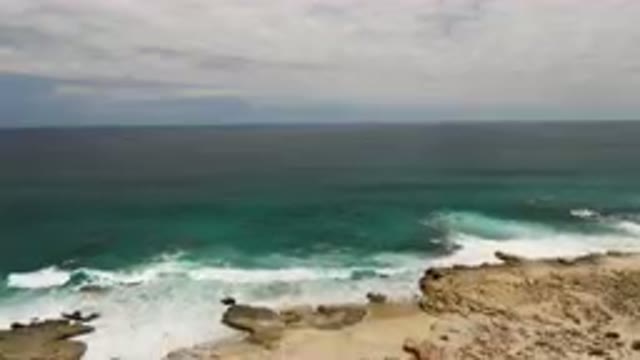 LAGUNA BEACH EAST CAPE BCS MEXICO-2023: Man Standing On A Cliff Overlooking The Ocean