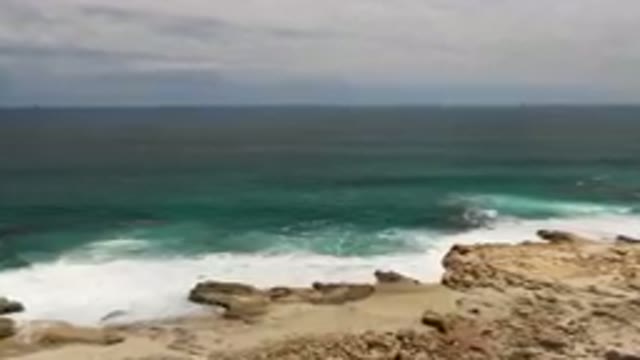 LAGUNA BEACH EAST CAPE BCS MEXICO-2023: Man Standing On A Cliff Overlooking The Ocean